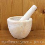 beige marble mortar and pestle